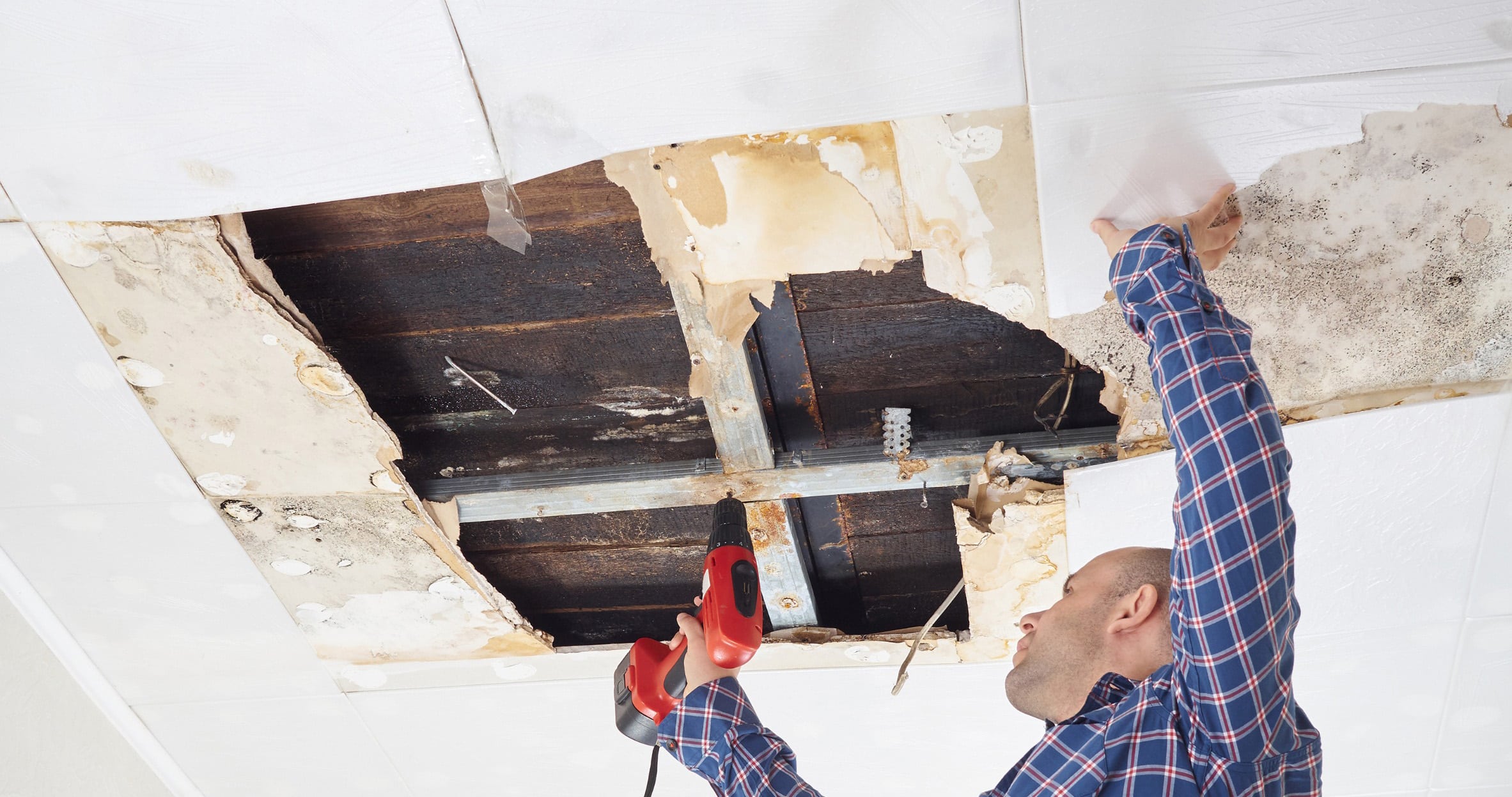 Man repairing collapsed ceiling